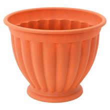 Oranžová misa na stopke s vertikálnymi pruhmi.