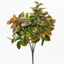 Umelé kvety so zelenými a hnedkastými listami.