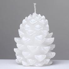 Biela sviečka v tvare šišky.