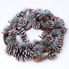 Vianočný veniec so šiškami a červenými plodmi.