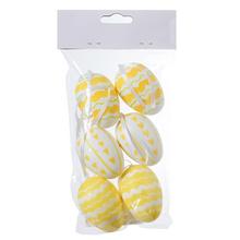 Sada plastových vajíčok bielej a žltej farby.