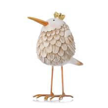 Dekorácia vtáčik bielej a béžovej farby s oranžovým zobákom a zlatou korunou.
