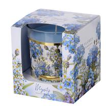 Voňavá sviečka v skle s modrými kvetmi.