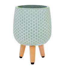 Mentolový kvetináč s nohami a hexagonálnym vzorom.