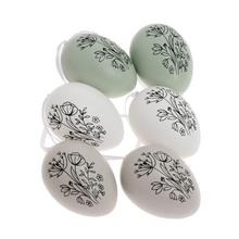 Sada plastových vajíčok s kvetinovým vzorom v mentolovej, bielej a krémovej farbe.