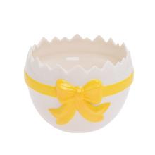 Obal škrupina bielej a žltej farby s mašľou.