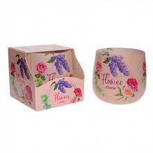 Sviečka vo vôni kvetov v sklenenom obale.