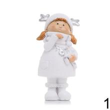 Dve deti v bielych zimných oblekoch s darčekmi.