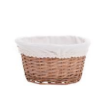 Oválny košík s bielou látkou a šedým vzorom.