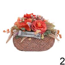 Smútočná väzba s kvetinami a sochou anjela.