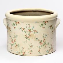 Keramický obal s kvetinovým vzorom.