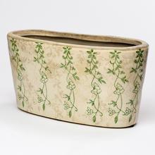 Keramický obal hrantík so zeleným vzorom.