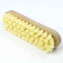 Ručná kefa na podlahu s drevenou rukoväťou a žltými štetinami.