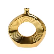 Zlatá keramická váza s otvorom a vlnkovým vzorom.