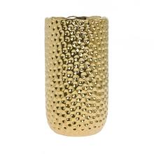 Zlatá keramická váza s textúrovaným povrchom.