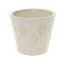 Krémový kvetináč s vzorom trávy.