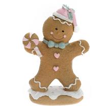 Perníček s lízatkom v bielej, ružovej, tyrkysovej a hnedej farbe.