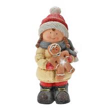 Dievča s perníkom v zimnom oblečení.