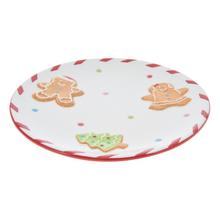 Tanier s vianočným motívom a perníkovými postavičkami.